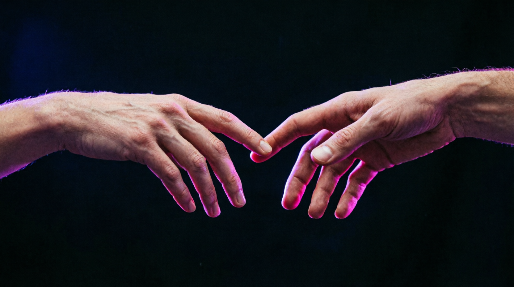 Two hands reaching in violet light